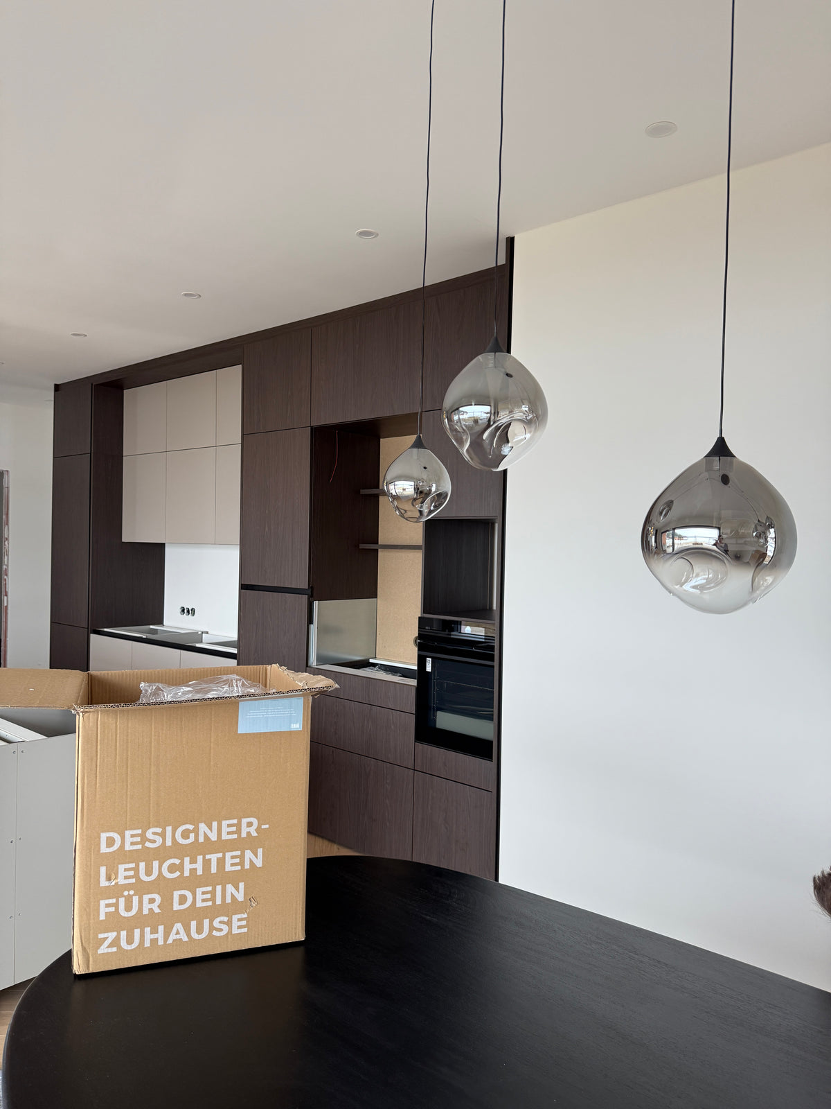 Moving boxes in a bright, still-empty room, styled friendly rather than chaotic (landscape)